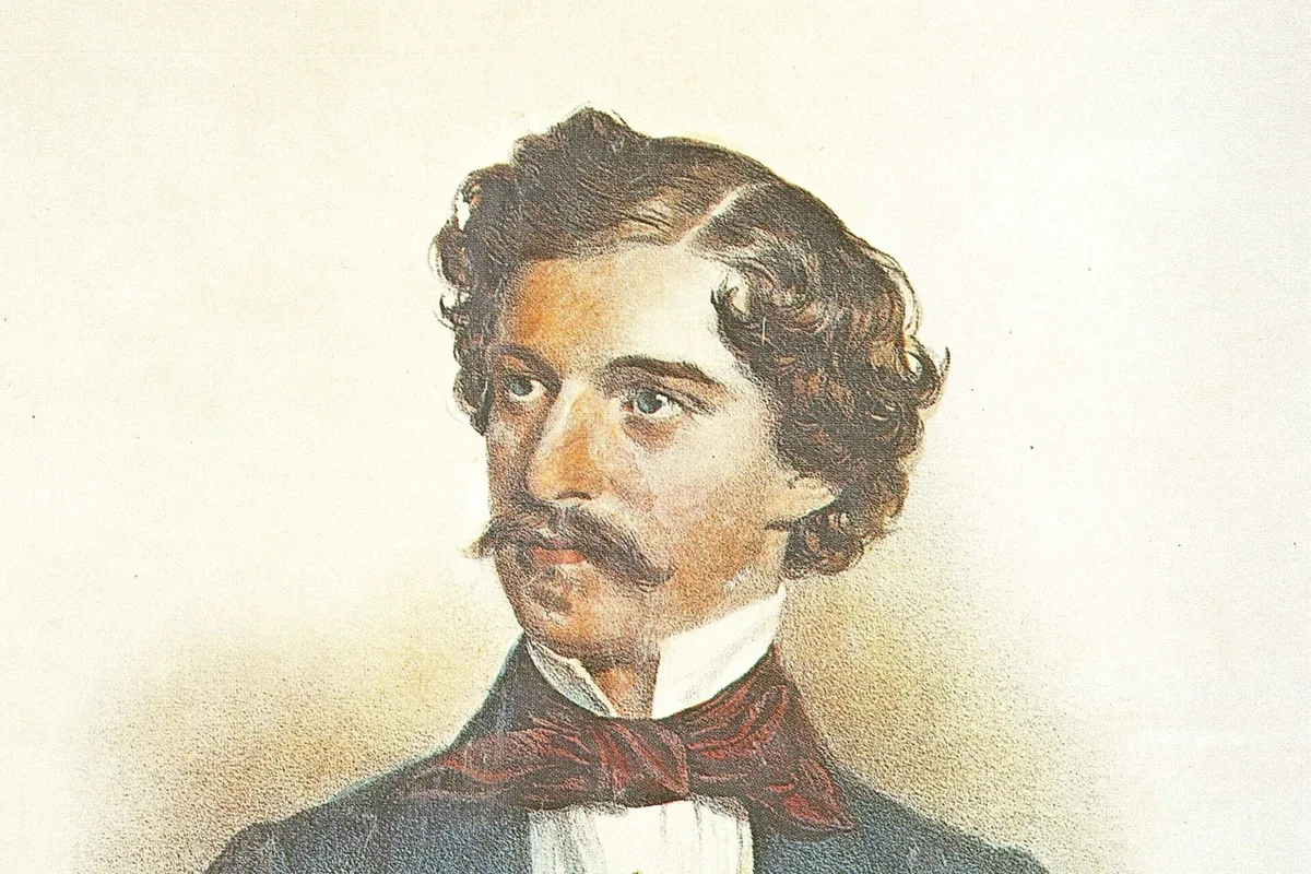 A coloured lithograph of a young man with wavy dark hair and a moustache, in a blue coat with a red cravat